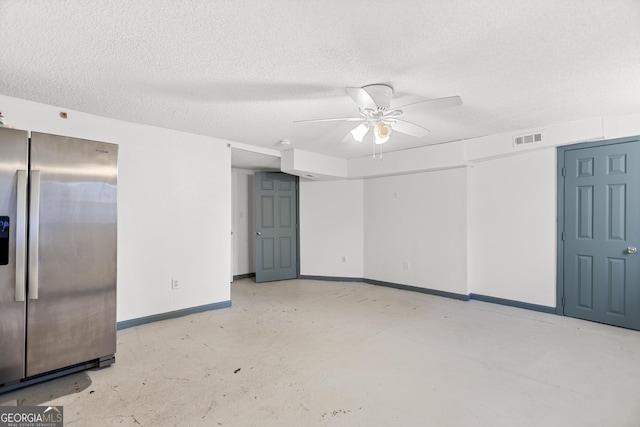 spare room with ceiling fan and a textured ceiling