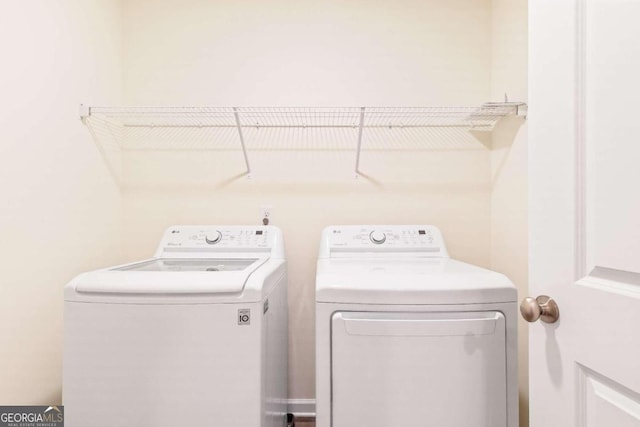 clothes washing area featuring washer and clothes dryer