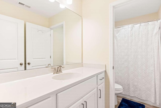 bathroom featuring vanity and toilet