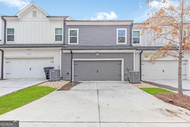 multi unit property featuring central AC unit and a garage