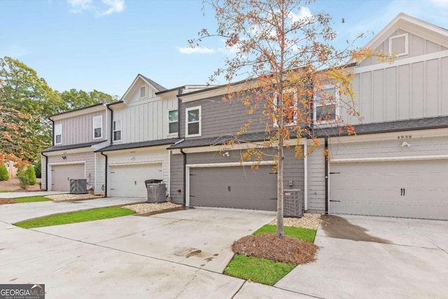 view of property featuring a garage and cooling unit