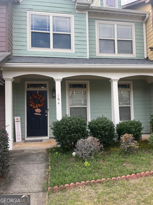 property entrance featuring a porch