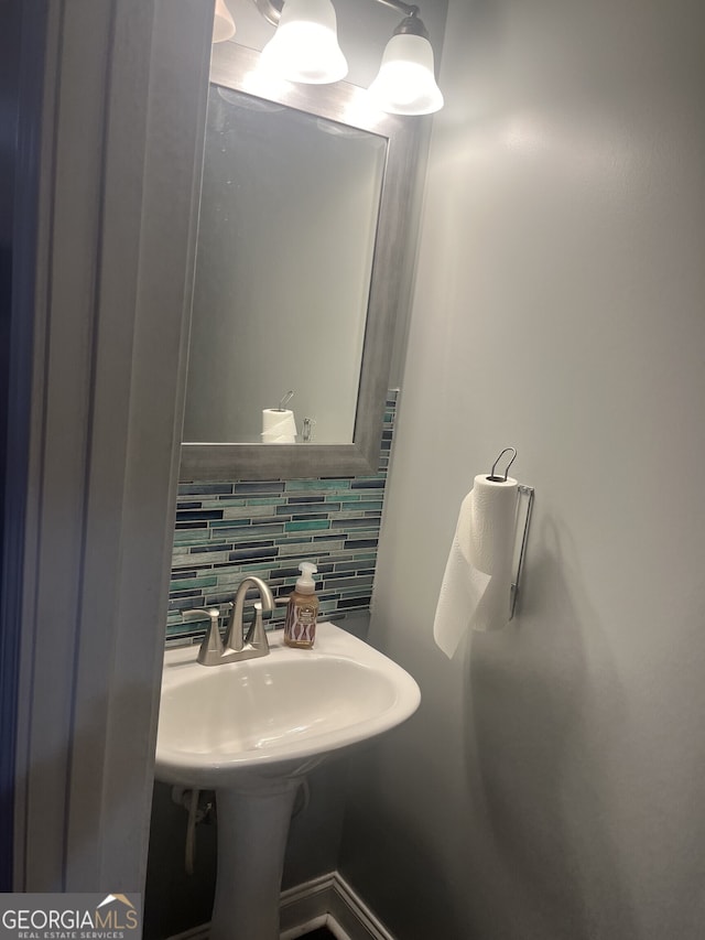 bathroom with backsplash and sink