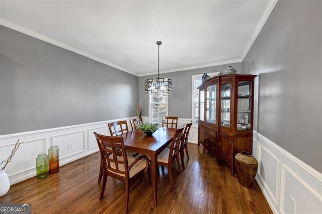 dining area with an inviting chandelier, dark hardwood / wood-style floors, and ornamental molding