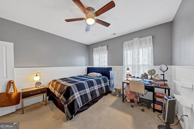 bedroom featuring ceiling fan and light carpet