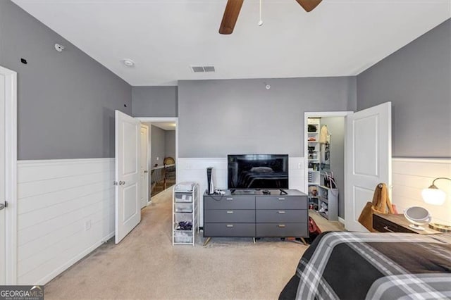 bedroom featuring light carpet and ceiling fan