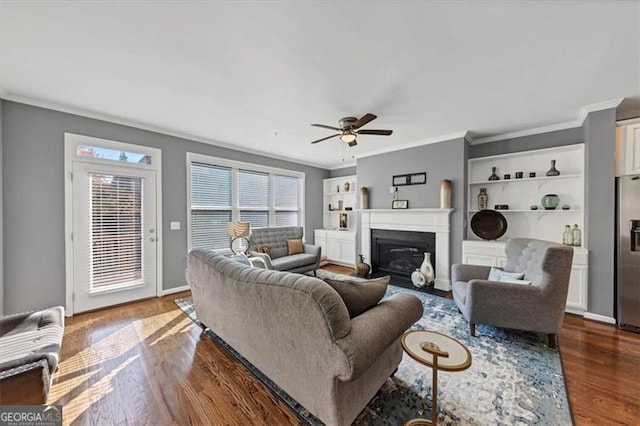 living room with dark hardwood / wood-style floors, ceiling fan, and crown molding