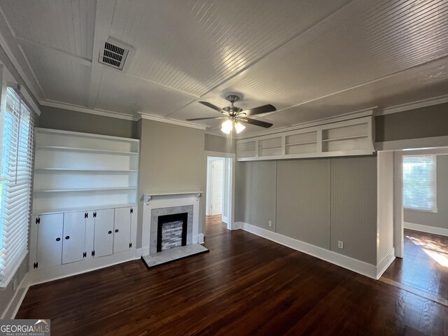 unfurnished living room featuring ceiling fan, dark hardwood / wood-style flooring, and crown molding