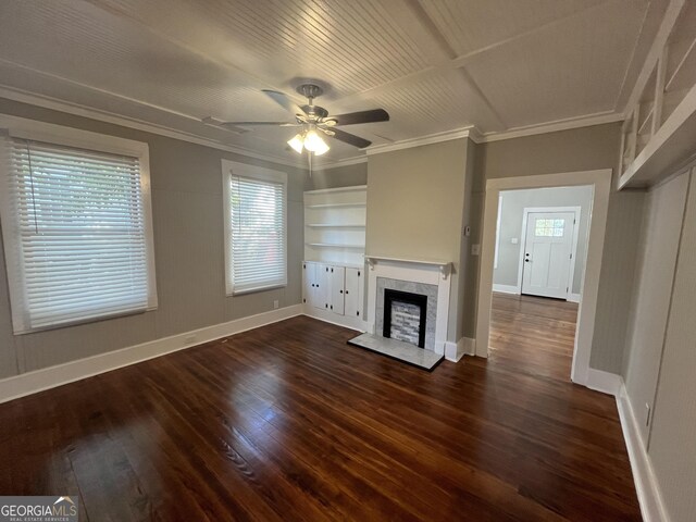 unfurnished bedroom with ceiling fan, ornamental molding, and dark wood-type flooring