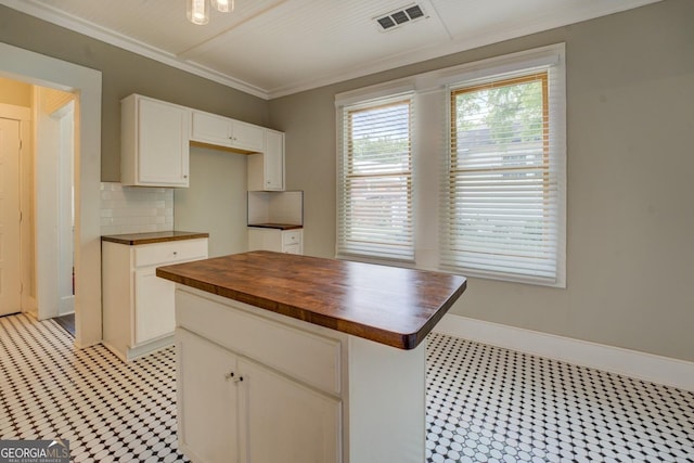 31 N Broad St, Porterdale, GA 30014 - kitchen with wooden counters, light floors, tasteful backsplash, white cabinets, and baseboards