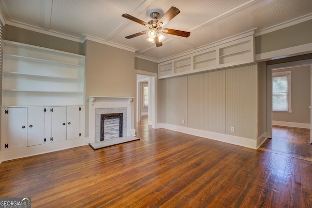 31 N Broad St, Porterdale, GA 30014 - unfurnished living room with ceiling fan, wood finished floors, healthy amount of natural light, a fireplace with raised hearth, and ornamental molding