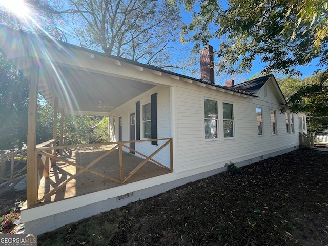 view of property exterior with a wooden deck