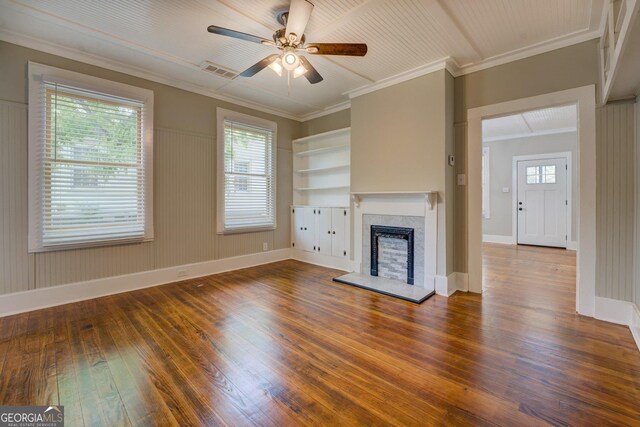 31 N Broad St, Porterdale, GA 30014 - unfurnished living room with hardwood / wood-style flooring, ceiling fan, a fireplace with raised hearth, healthy amount of natural light, and ornamental molding
