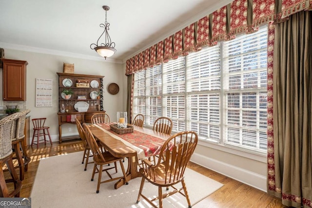 dining room featuring ornamental molding and light hardwood / wood-style flooring