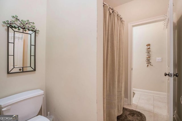 bathroom with tile patterned flooring and toilet