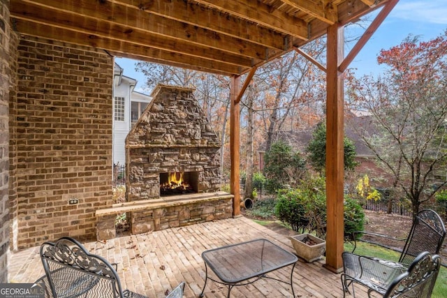 view of patio with an outdoor stone fireplace