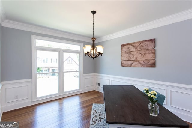 interior space with dark wood-type flooring, ornamental molding, and a notable chandelier