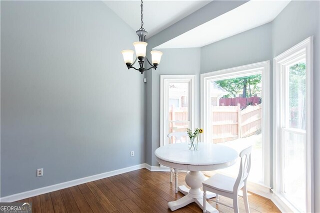 dining room featuring wood-type flooring and a notable chandelier