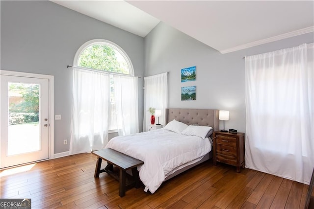 bedroom with high vaulted ceiling, wood-type flooring, and access to outside