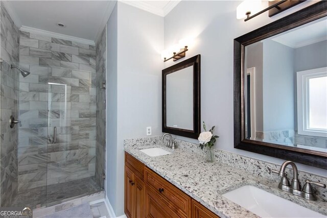 bathroom with vanity, a shower with shower door, and crown molding