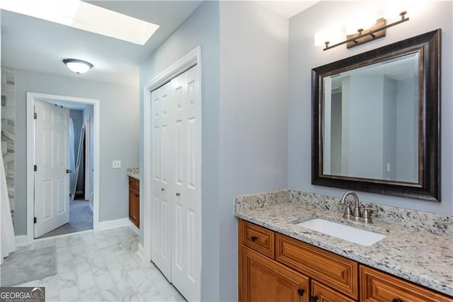 bathroom with vanity and a skylight