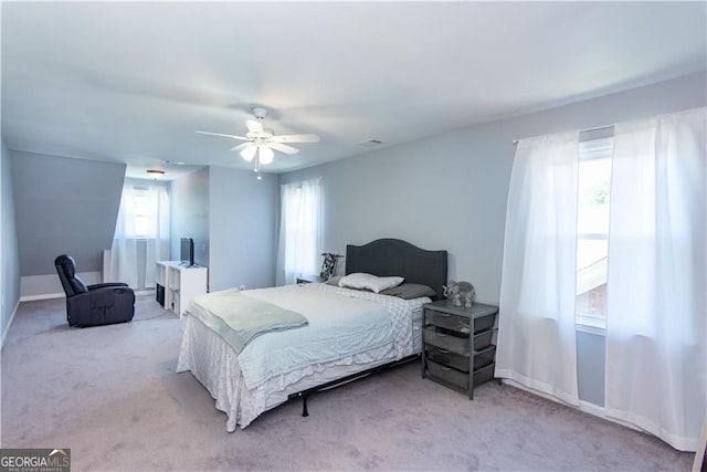 bedroom featuring light carpet and ceiling fan