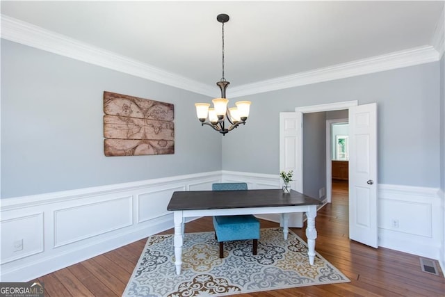 home office with dark hardwood / wood-style flooring, crown molding, and a chandelier