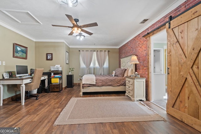 bedroom featuring hardwood / wood-style floors, crown molding, ceiling fan, a barn door, and brick wall