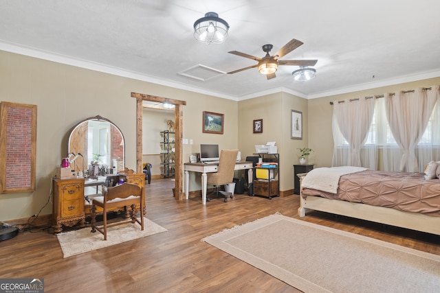 bedroom featuring hardwood / wood-style floors, ceiling fan, and ornamental molding