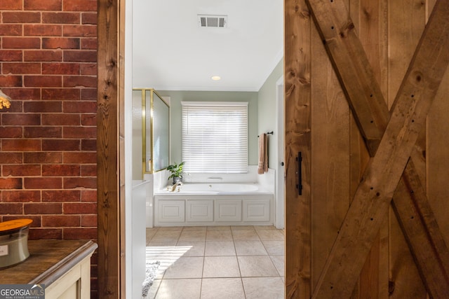 bathroom featuring tile patterned flooring, a bath, and ornamental molding