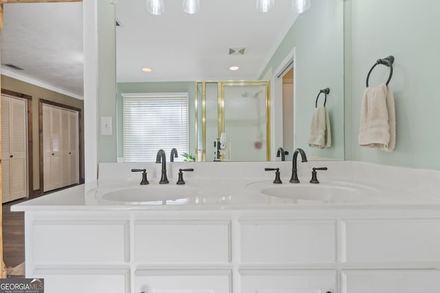 bathroom featuring hardwood / wood-style floors, vanity, an enclosed shower, and ornamental molding