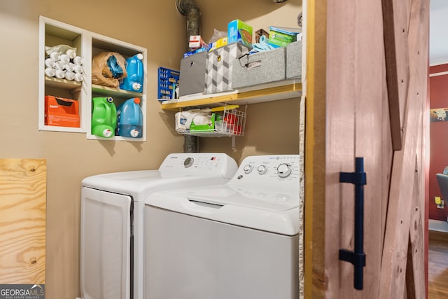 laundry area with washing machine and clothes dryer and hardwood / wood-style floors