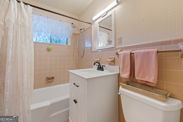 full bathroom with shower / bath combo with shower curtain, vanity, tile walls, and toilet