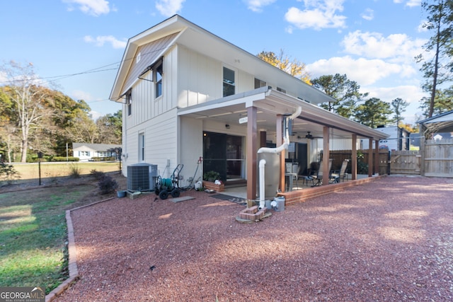 rear view of house with a patio area, ceiling fan, and cooling unit