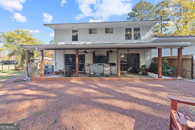 back of property with a patio area and ceiling fan