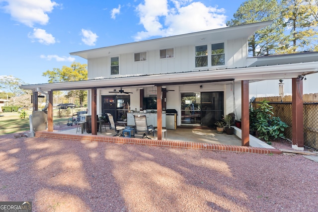 rear view of property featuring ceiling fan and a patio