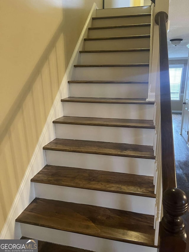 stairs featuring hardwood / wood-style floors