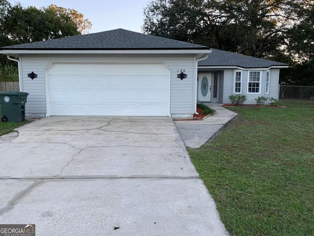 ranch-style home with a front yard and a garage