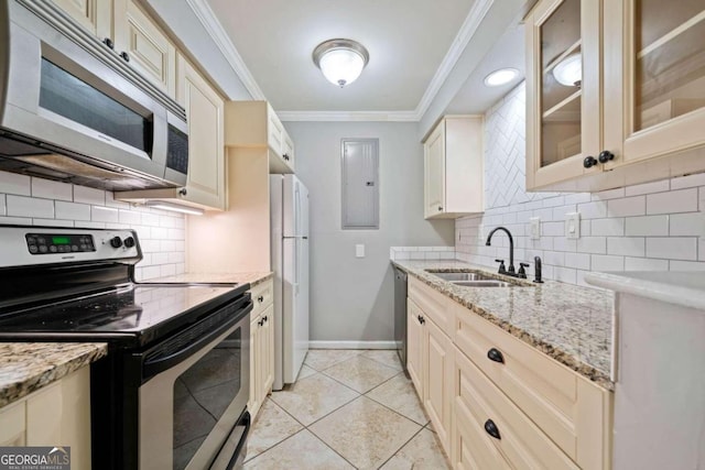 kitchen featuring tasteful backsplash, stainless steel appliances, sink, light tile patterned floors, and cream cabinetry