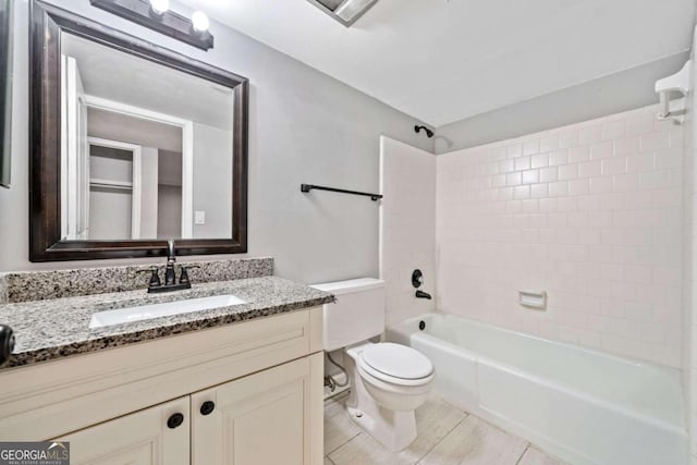 full bathroom with tiled shower / bath combo, toilet, and vanity