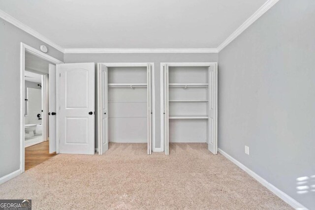 unfurnished bedroom with crown molding and light carpet