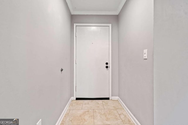 doorway to outside with light tile patterned floors and ornamental molding