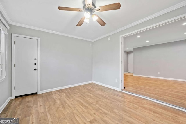 empty room with light hardwood / wood-style flooring, ceiling fan, and ornamental molding