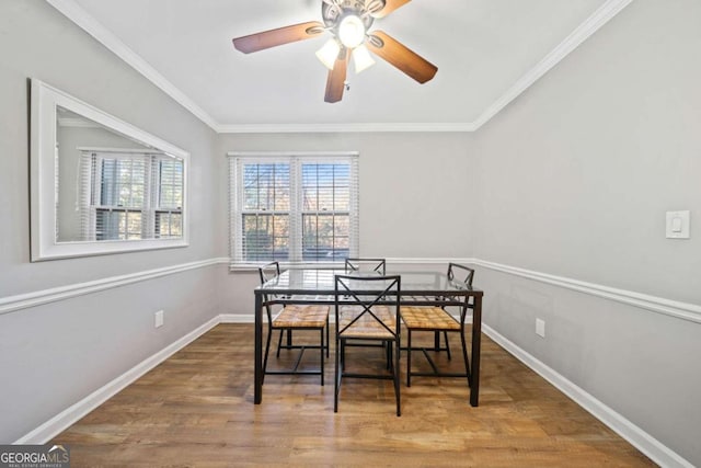 dining area with hardwood / wood-style flooring, ceiling fan, and crown molding