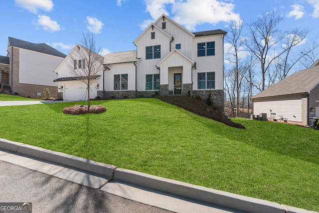 modern farmhouse style home with a front yard, a garage, and central air condition unit