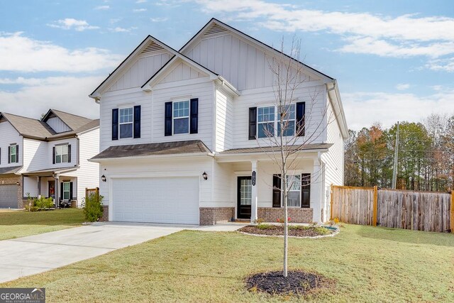 view of front of property featuring a garage and a front lawn