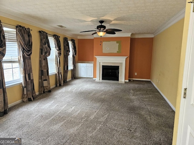 unfurnished living room featuring a textured ceiling, carpet floors, ceiling fan, and crown molding