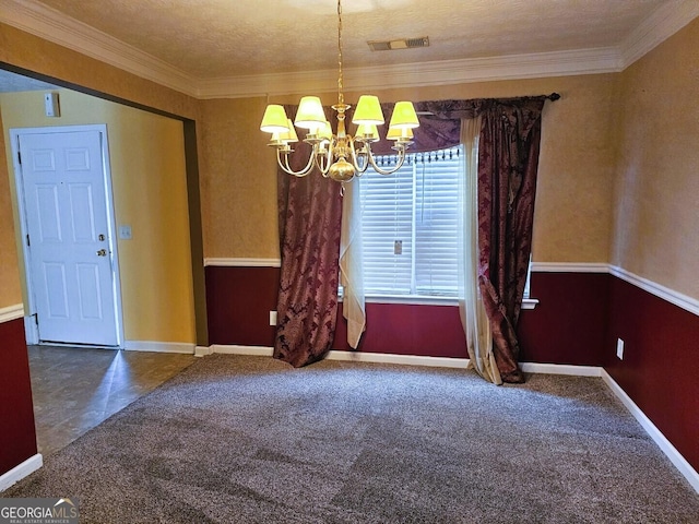 carpeted empty room with a chandelier, a textured ceiling, and ornamental molding