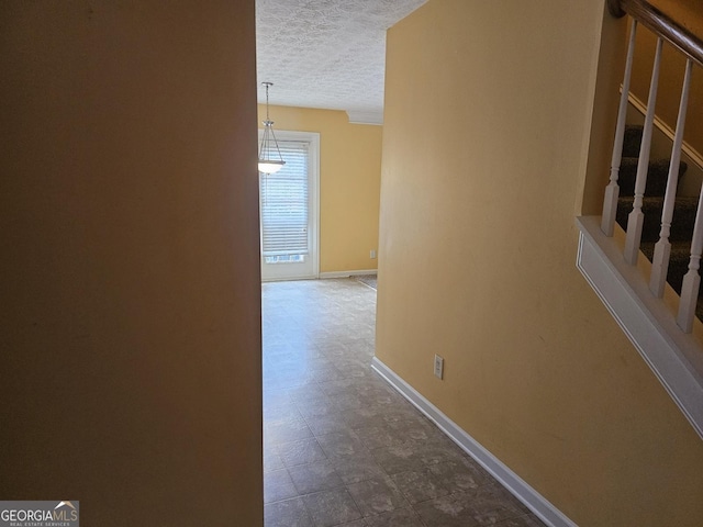 corridor featuring a textured ceiling