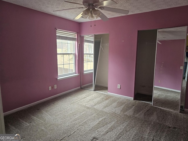 unfurnished bedroom featuring carpet, a textured ceiling, a closet, and ceiling fan